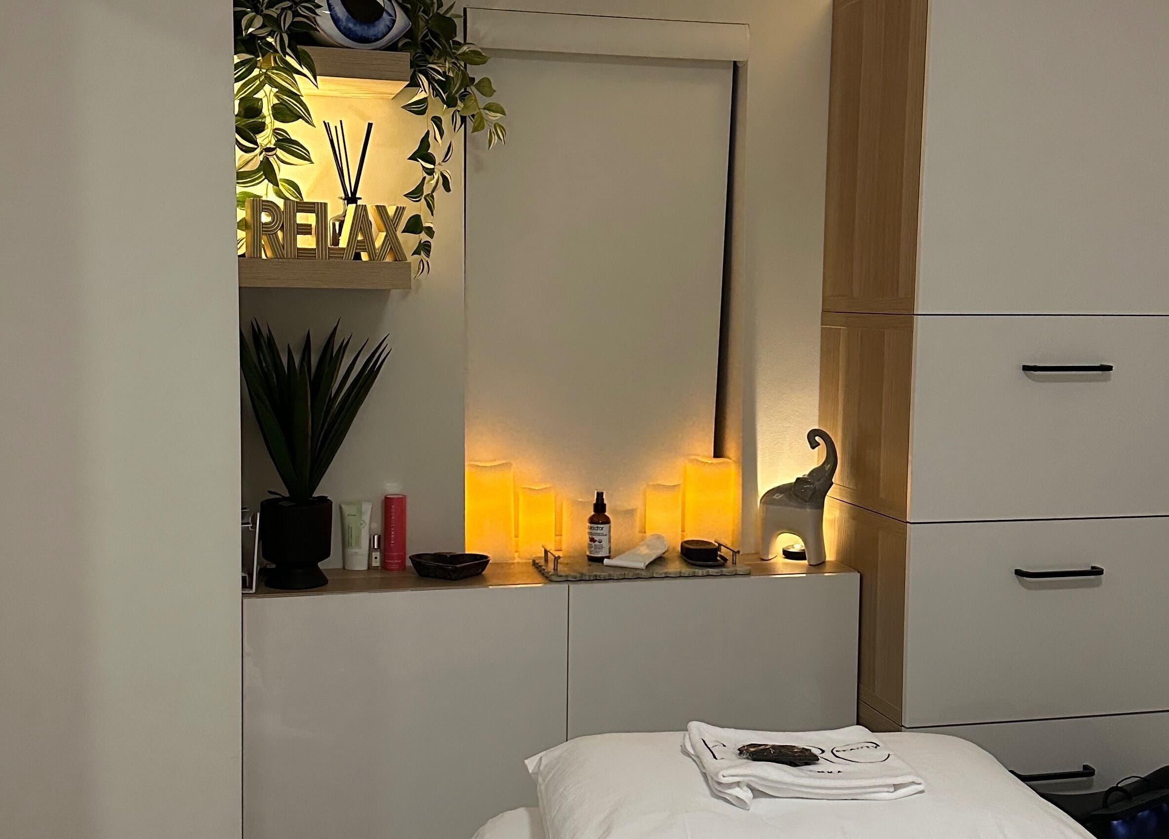 Calming spa room at BareBeauty By Bianka, Toronto, Ontario, CA with soft lighting and cozy treatment bed.