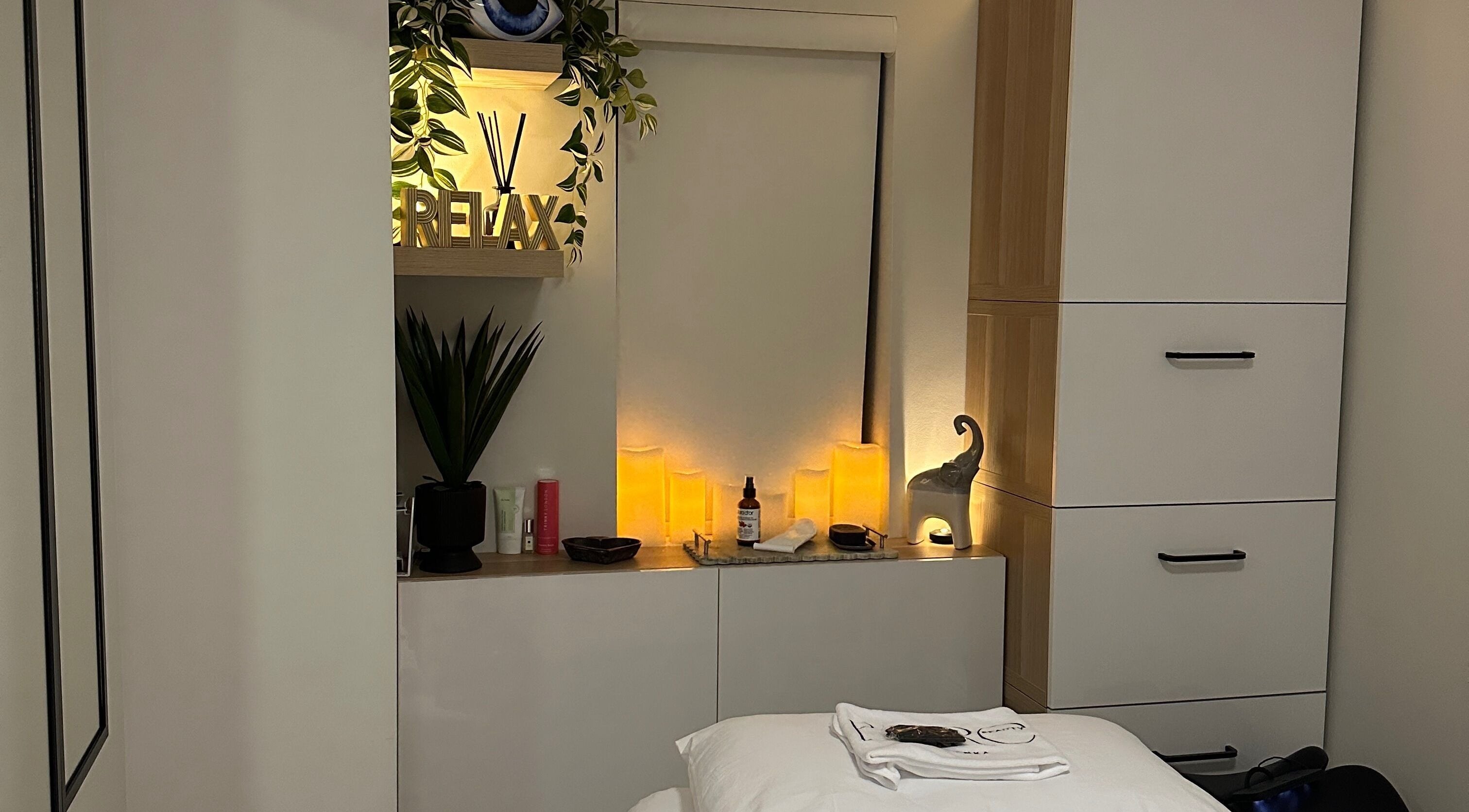 Calming spa room at BareBeauty By Bianka, Toronto, Ontario, CA with soft lighting and cozy treatment bed.