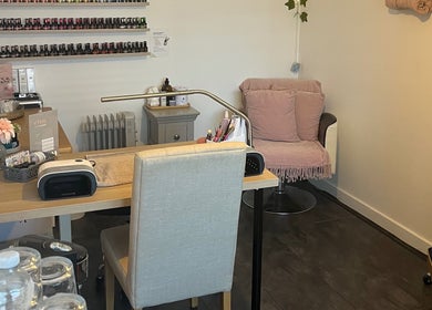 Pampered Pinkies nail studio in Great Yarmouth, England, features a cozy seating area and nail polish display.