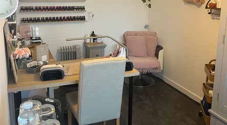 Pampered Pinkies nail studio in Great Yarmouth, England, features a cozy seating area and nail polish display.
