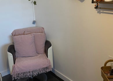 Cozy chair with pink throw at Pampered Pinkies, Great Yarmouth, England, GB. Relaxing beauty experience.