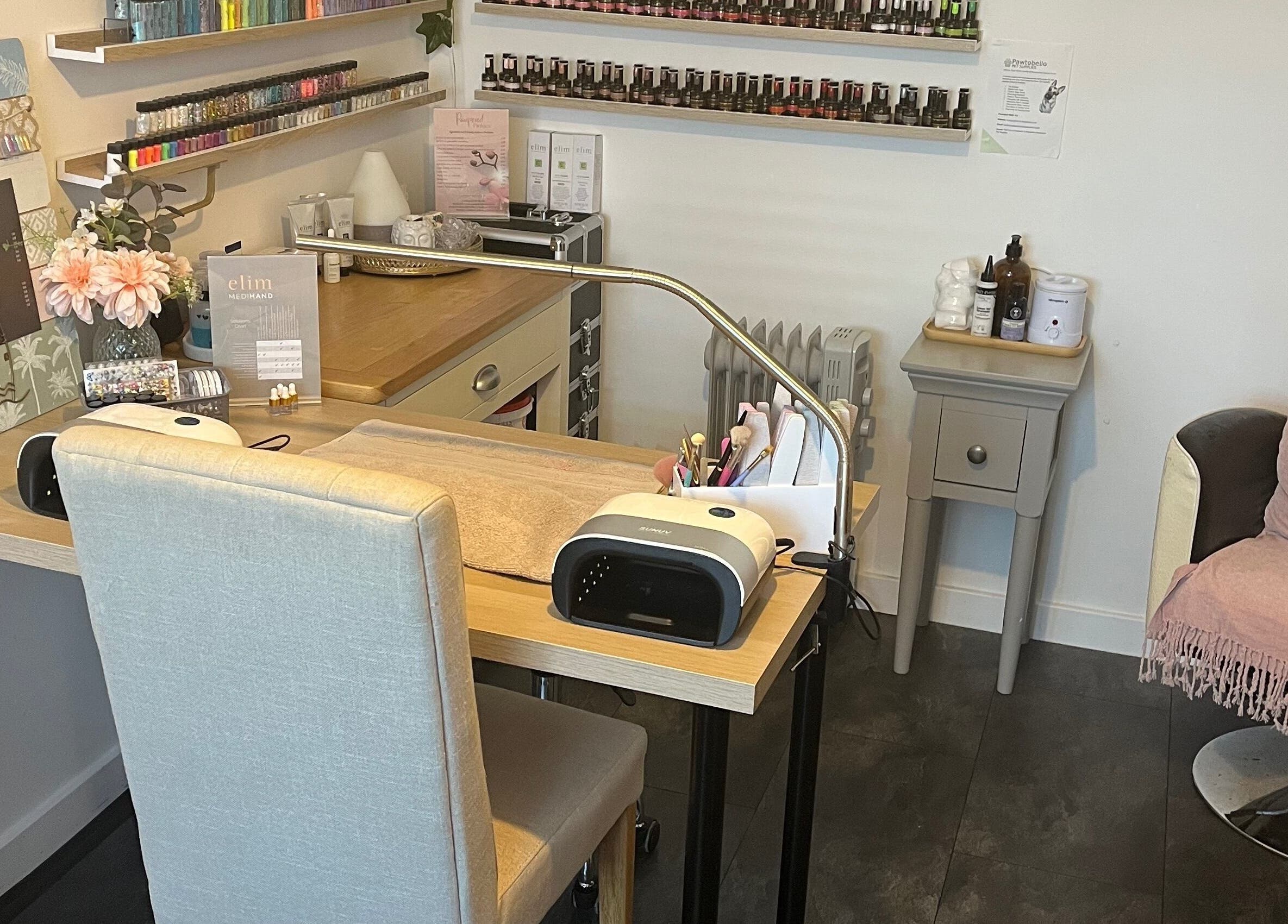 Modern nail treatment area at Pampered Pinkies, Great Yarmouth, England, GB with cozy seating and nail tools.