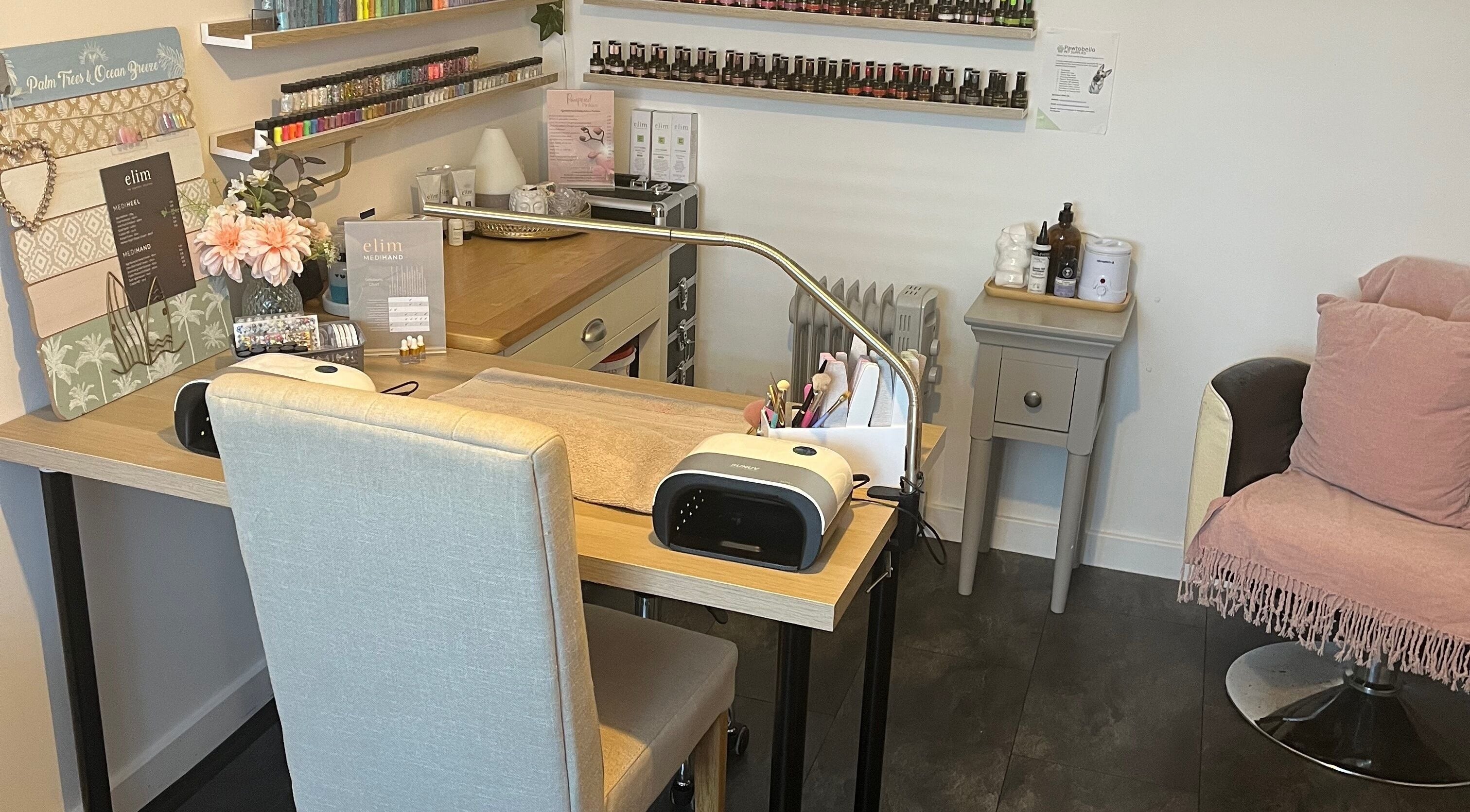 Modern nail treatment area at Pampered Pinkies, Great Yarmouth, England, GB with cozy seating and nail tools.