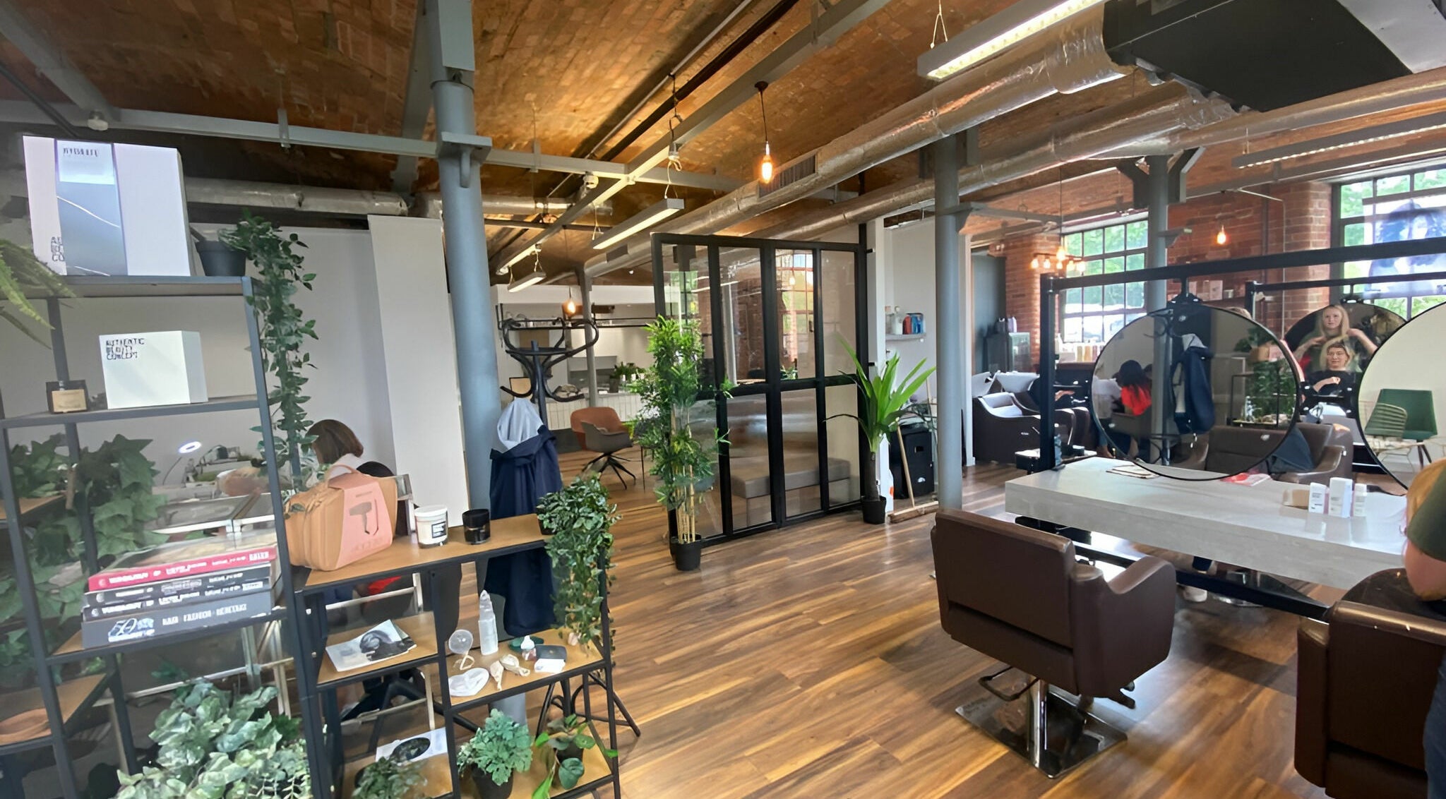 Modern salon interior at Hair Industry, Stalybridge, England, GB featuring stylish decor and seating.