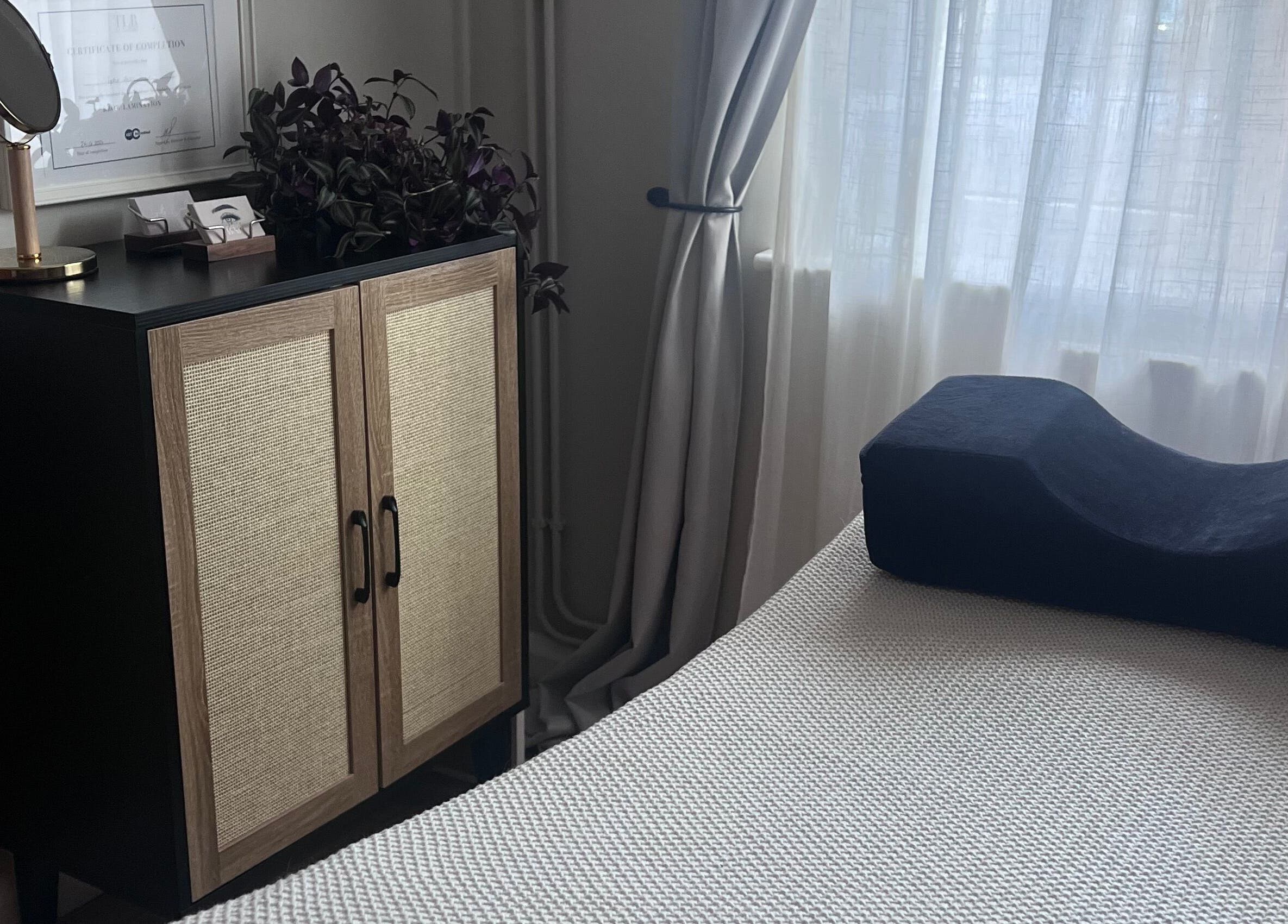 Relaxing room setup at Sophie's beauty bar, Midhurst, England, GB, featuring a cabinet and soft lighting.