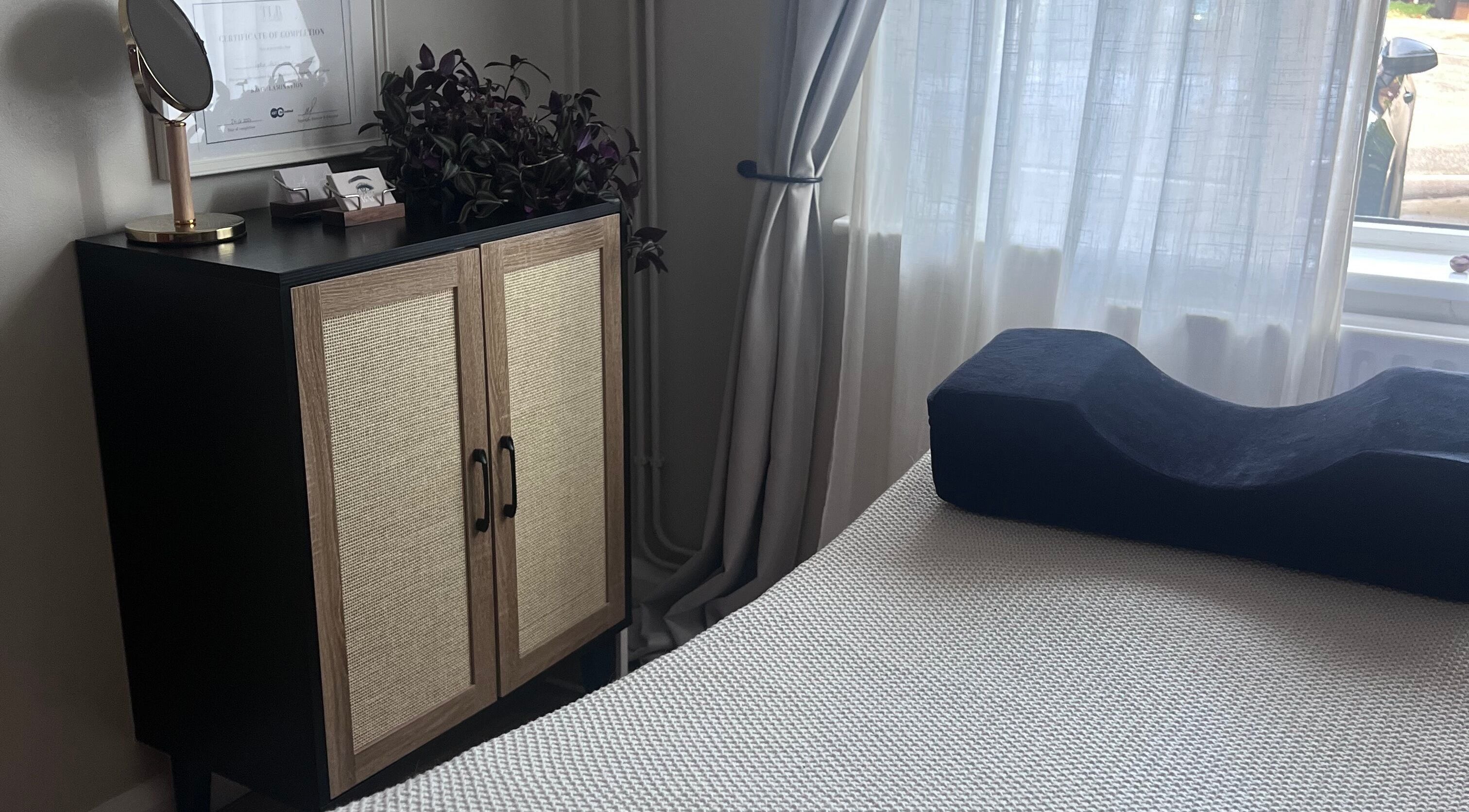 Relaxing room setup at Sophie's beauty bar, Midhurst, England, GB, featuring a cabinet and soft lighting.