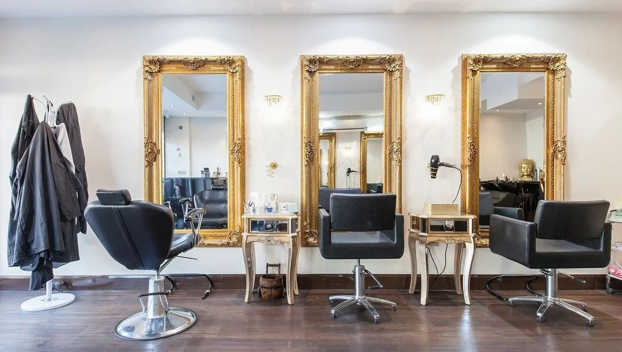 Elegant salon interior at Wink Spa with gold mirrors, Feltham, England, GB.