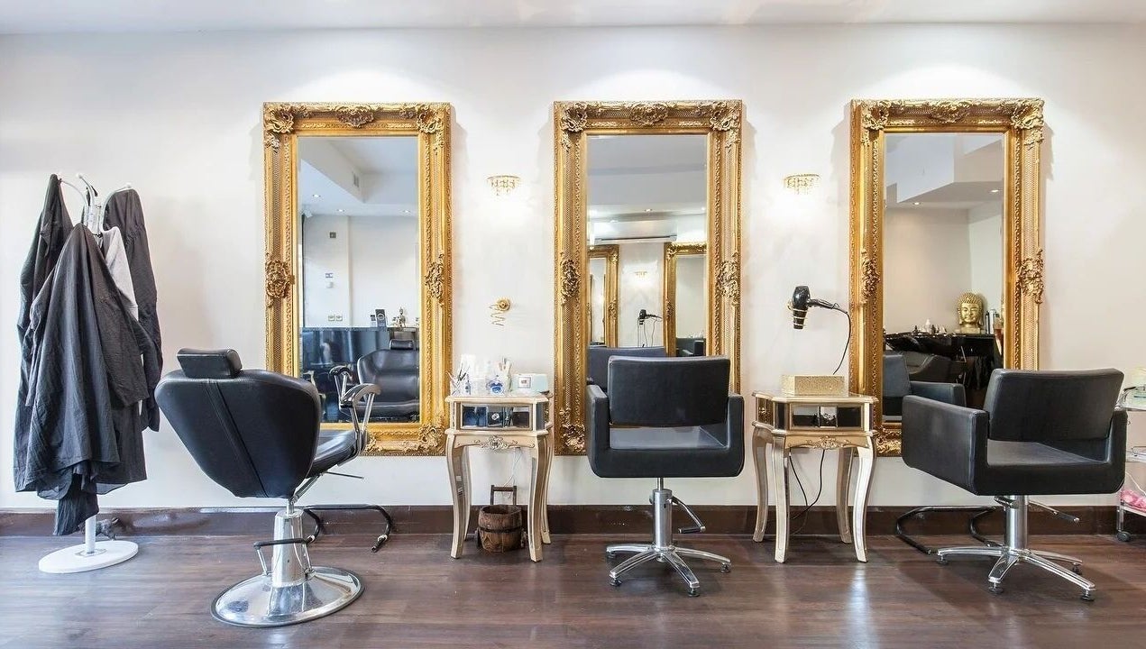 Elegant salon interior at Wink Spa with gold mirrors, Feltham, England, GB.