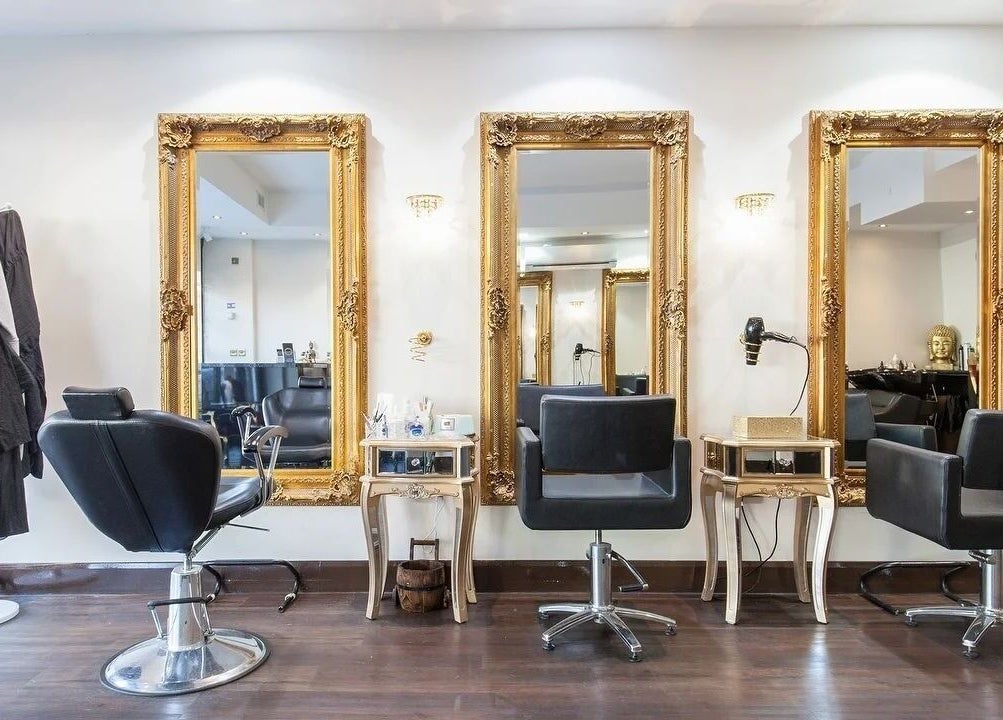 Elegant salon interior at Wink Spa with gold mirrors, Feltham, England, GB.