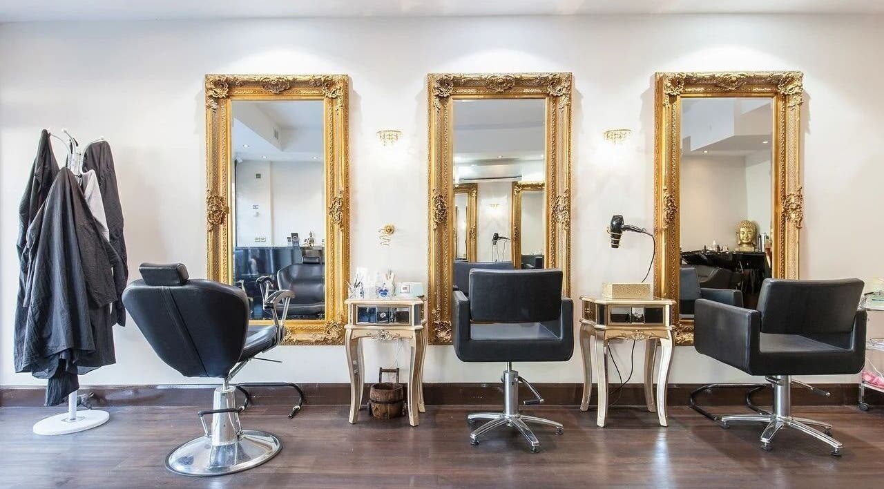 Elegant salon interior at Wink Spa with gold mirrors, Feltham, England, GB.