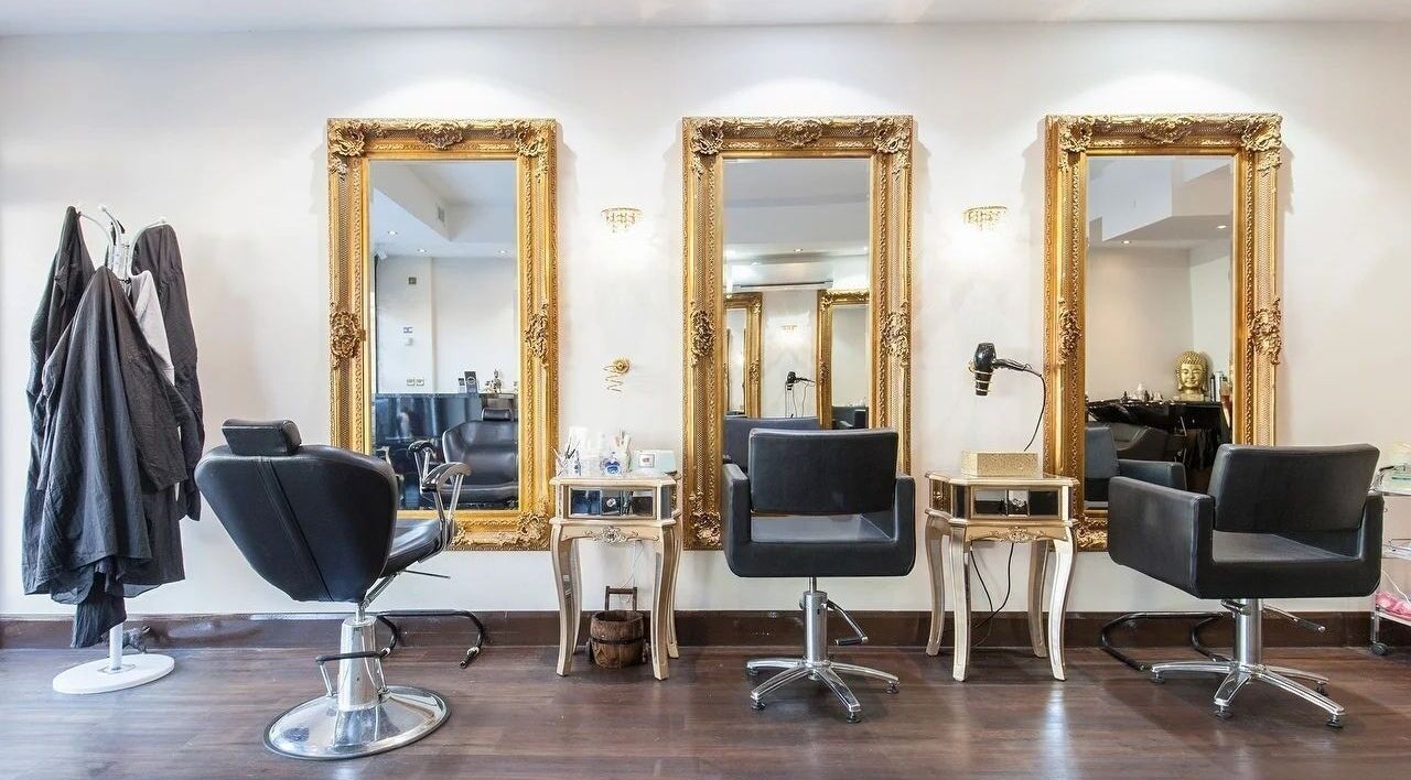 Elegant salon interior at Wink Spa with gold mirrors, Feltham, England, GB.