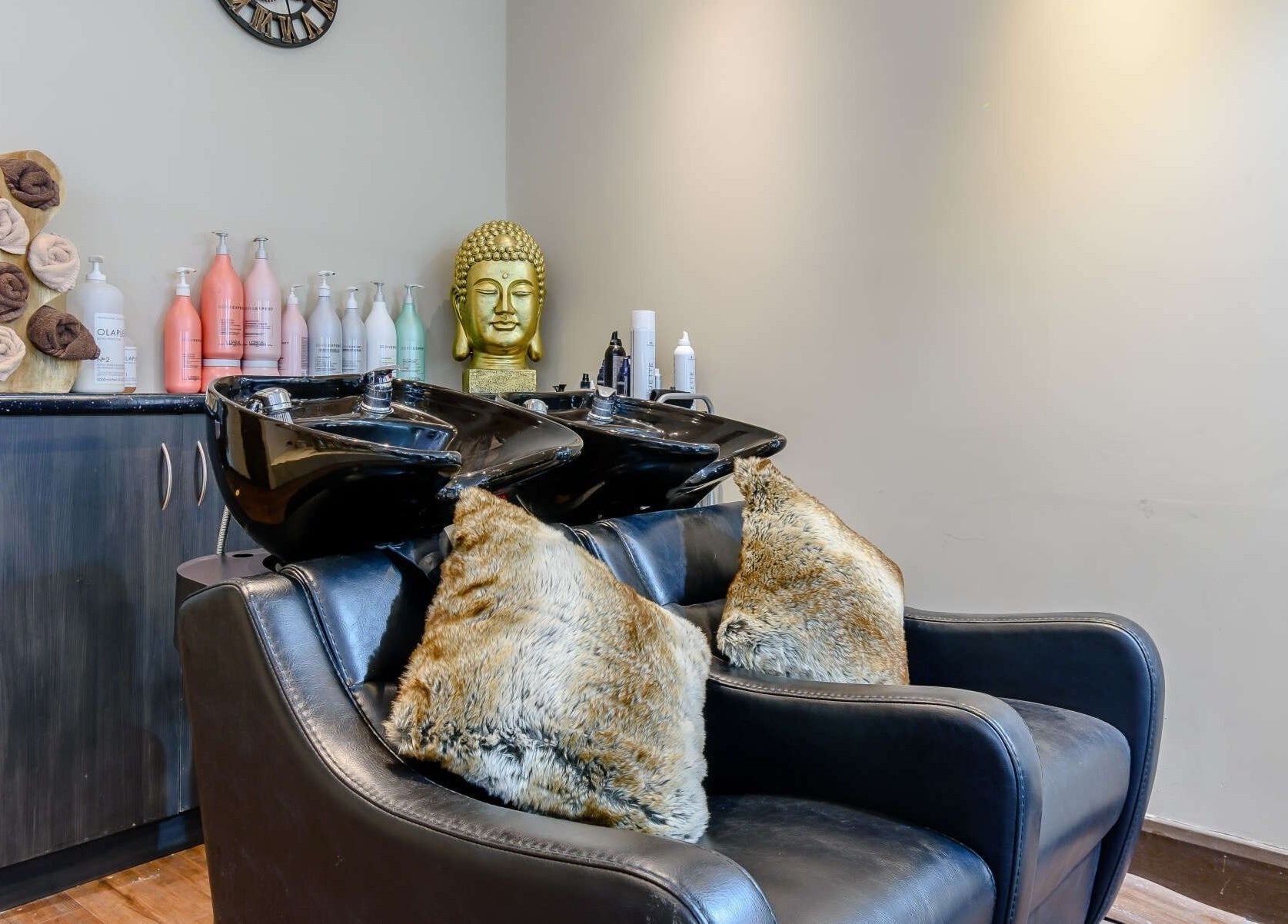 Elegant hair washing area at Wink Spa, Feltham, England, GB with plush seating and modern decor.