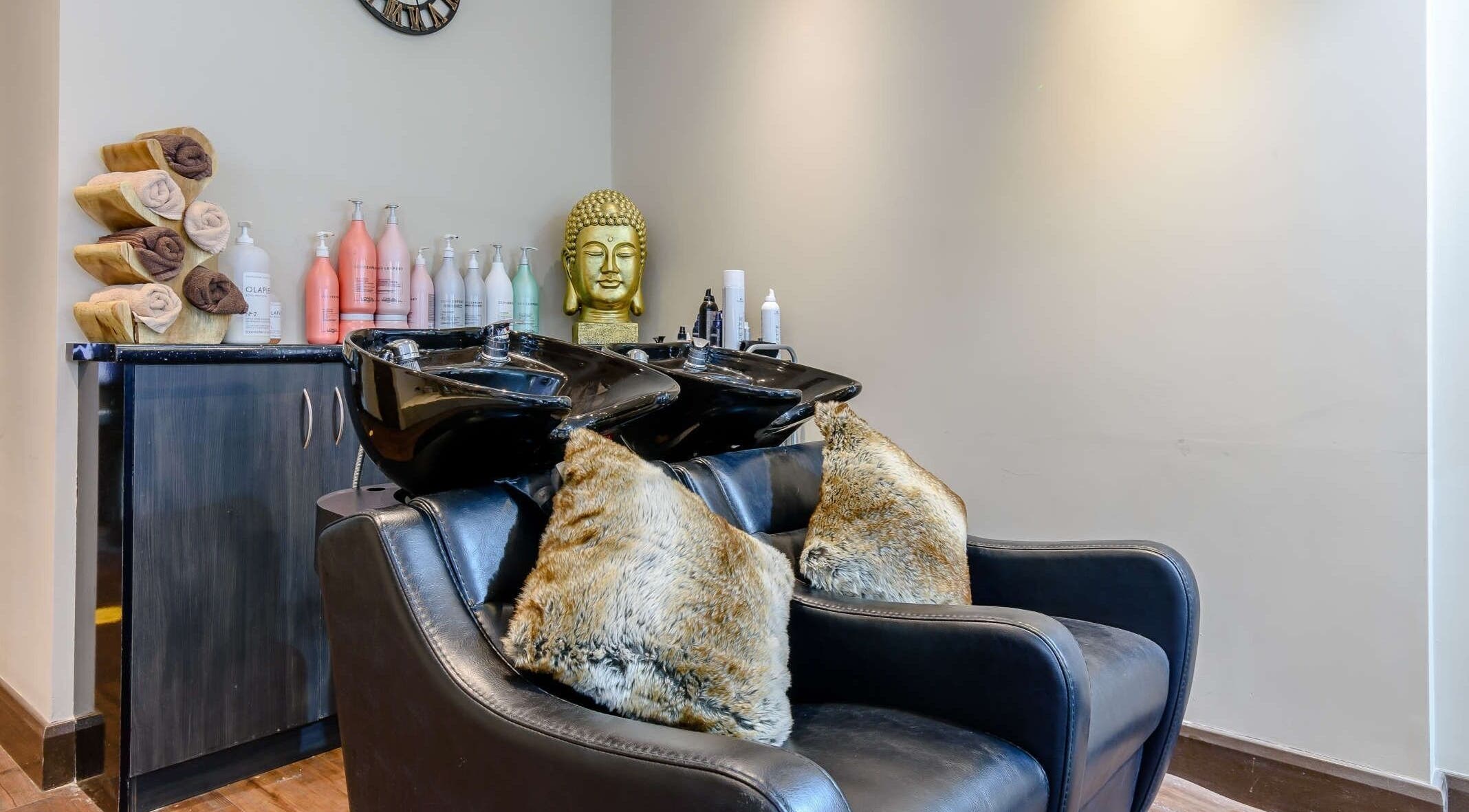 Elegant hair washing area at Wink Spa, Feltham, England, GB with plush seating and modern decor.