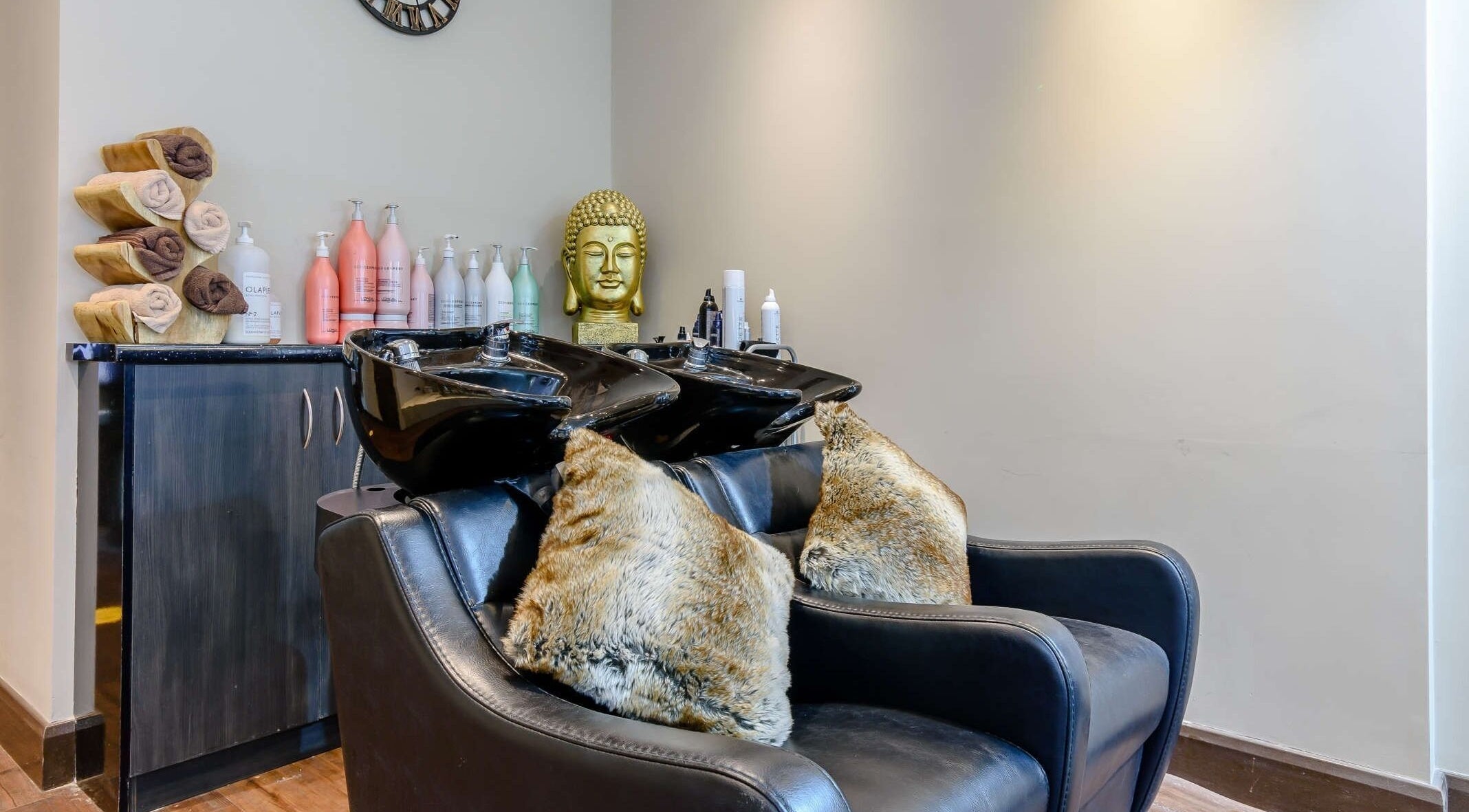Elegant hair washing area at Wink Spa, Feltham, England, GB with plush seating and modern decor.