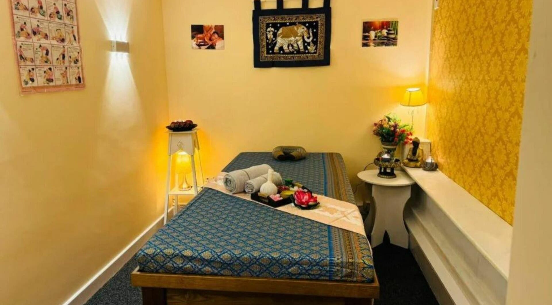 Serene massage room at My Thai Massage and Spa in Frodsham, England, GB, with a beautifully decorated table.