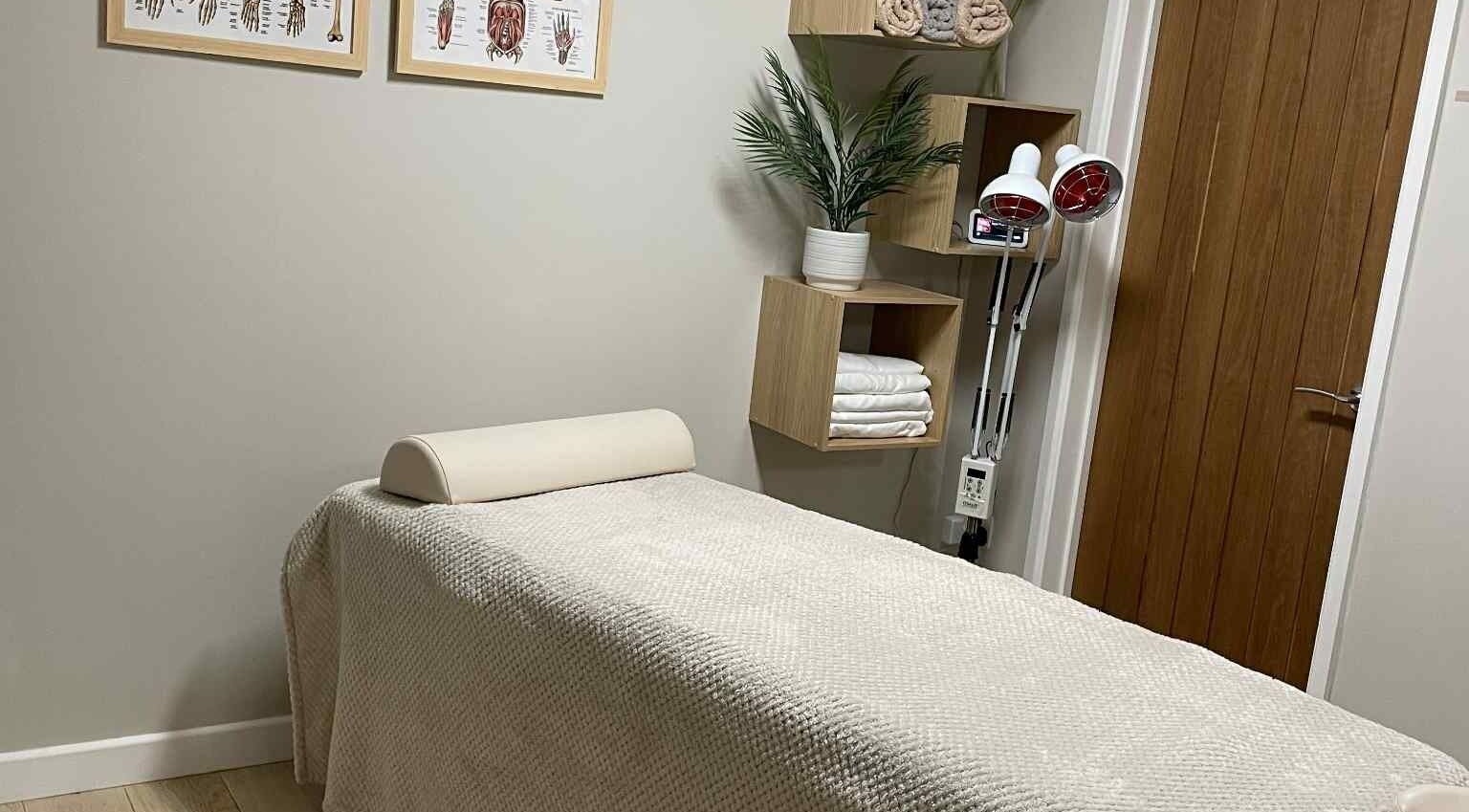 KT Sports Massage therapy room in Westbury, England, GB featuring a massage table and tranquil decor.