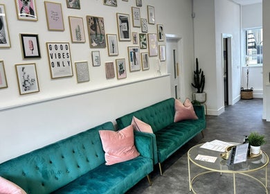 Elegant lounge at Olga Genc Beauty in Chichester, England, GB with stylish decor and vibrant teal sofas.