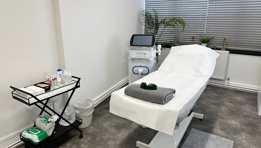 Modern treatment room at Olga Genc Beauty, Chichester, England, GB featuring a comfortable spa bed and equipment.
