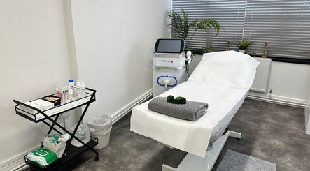 Modern treatment room at Olga Genc Beauty, Chichester, England, GB featuring a comfortable spa bed and equipment.