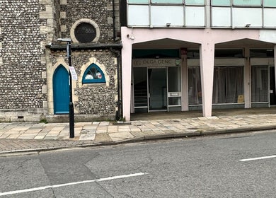 Entrance to Olga Genc Beauty on Chichester street, featuring historic stone architecture, Chichester, England, GB.