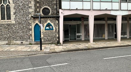 Entrance to Olga Genc Beauty on Chichester street, featuring historic stone architecture, Chichester, England, GB.