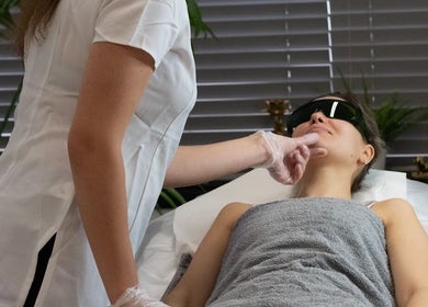 Client receiving a soothing facial treatment at Olga Genc Beauty, Chichester, England, GB.