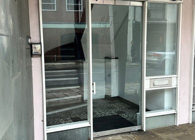 Entrance to Olga Genc Beauty, Chichester, England, GB, featuring glass door and modern design.