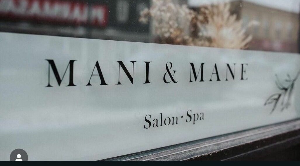 Mani & Mane salon window sign at Lucknow, Ontario, CA offering beauty and wellness services.