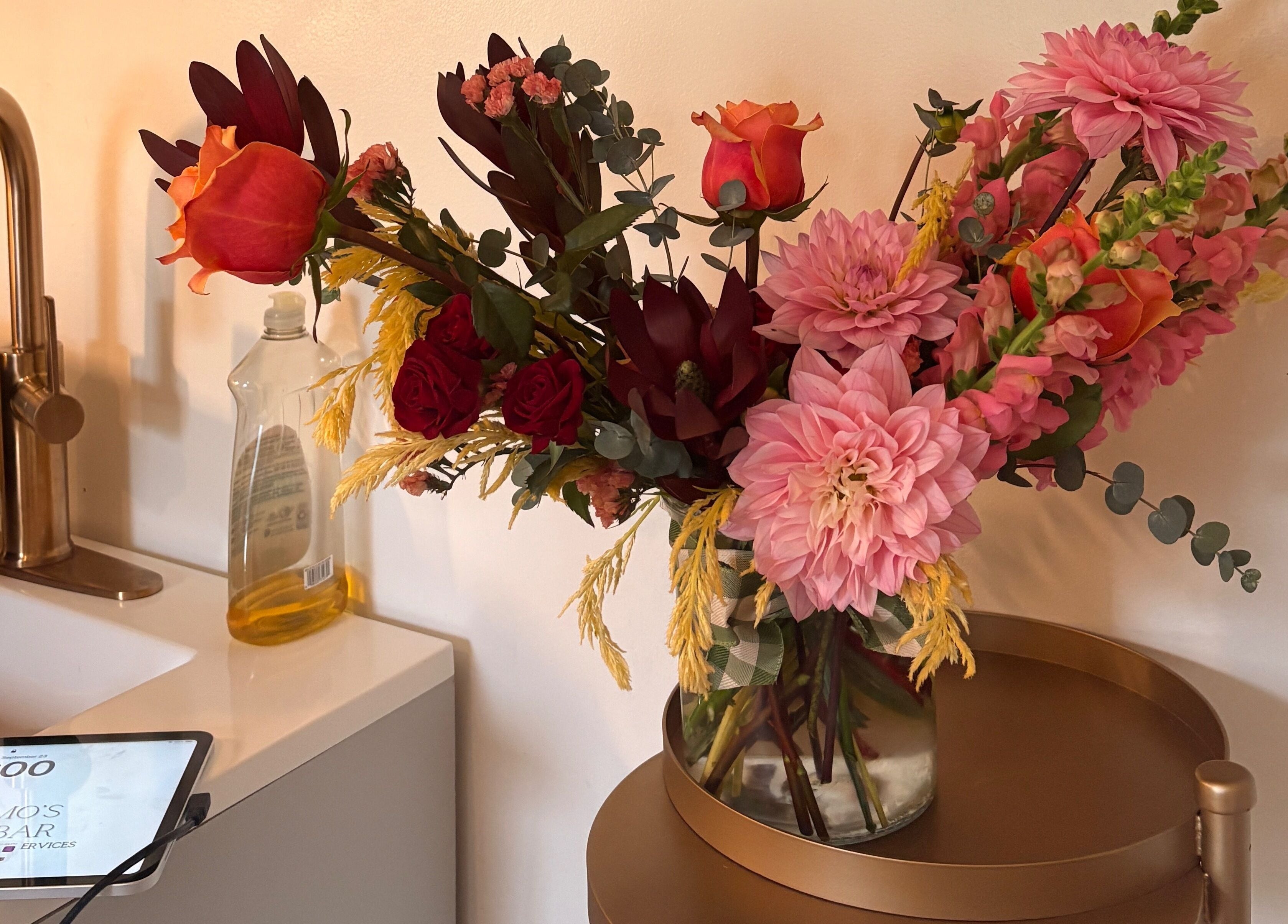 Elegant floral arrangement at Bellissimos Beauty Bar, Greater Sudbury, Ontario, CA showcases warm, inviting ambiance.