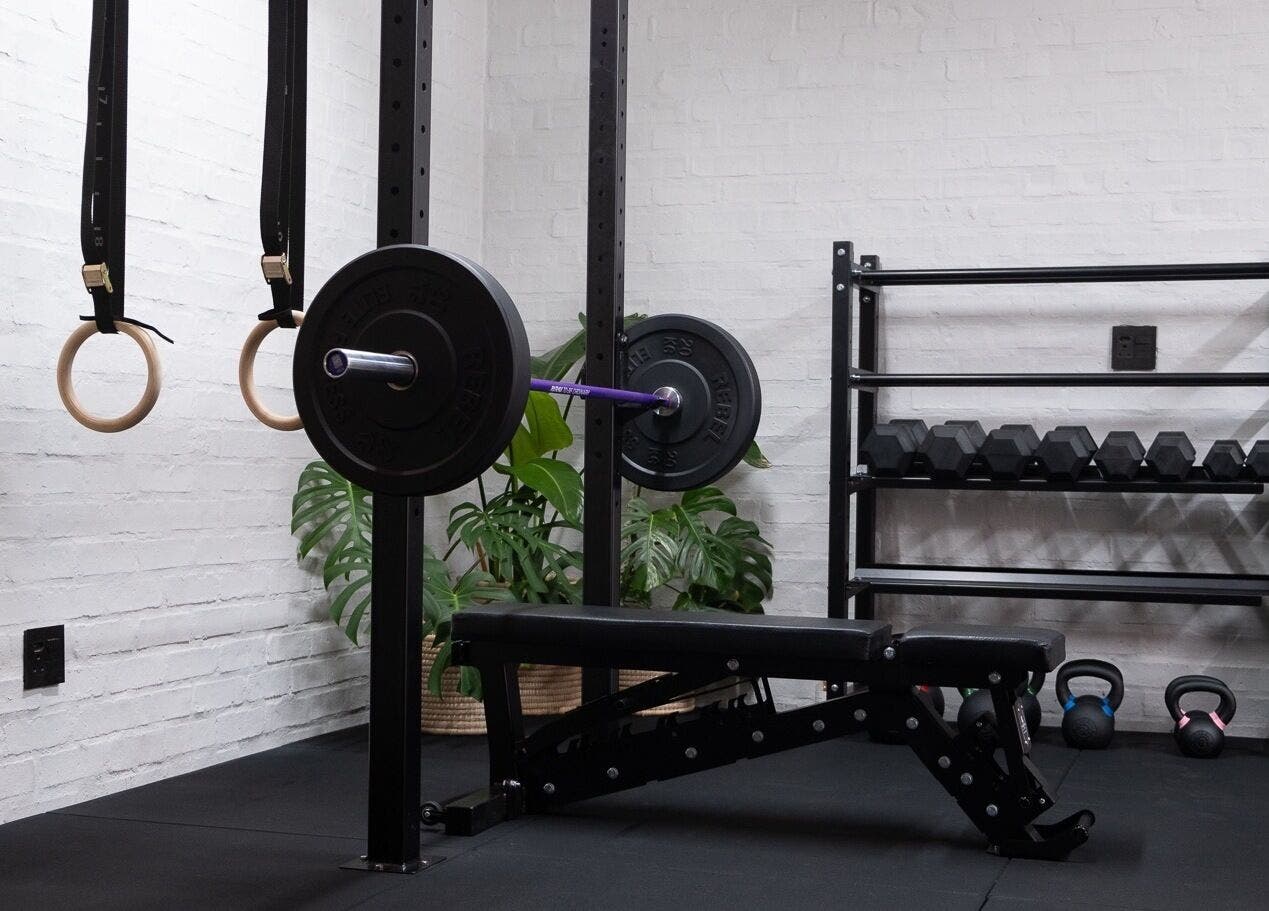 Modern gym setup at Seal Hybrid Performance, Cape Saint Francis, Eastern Cape, ZA, featuring weights and gym rings.