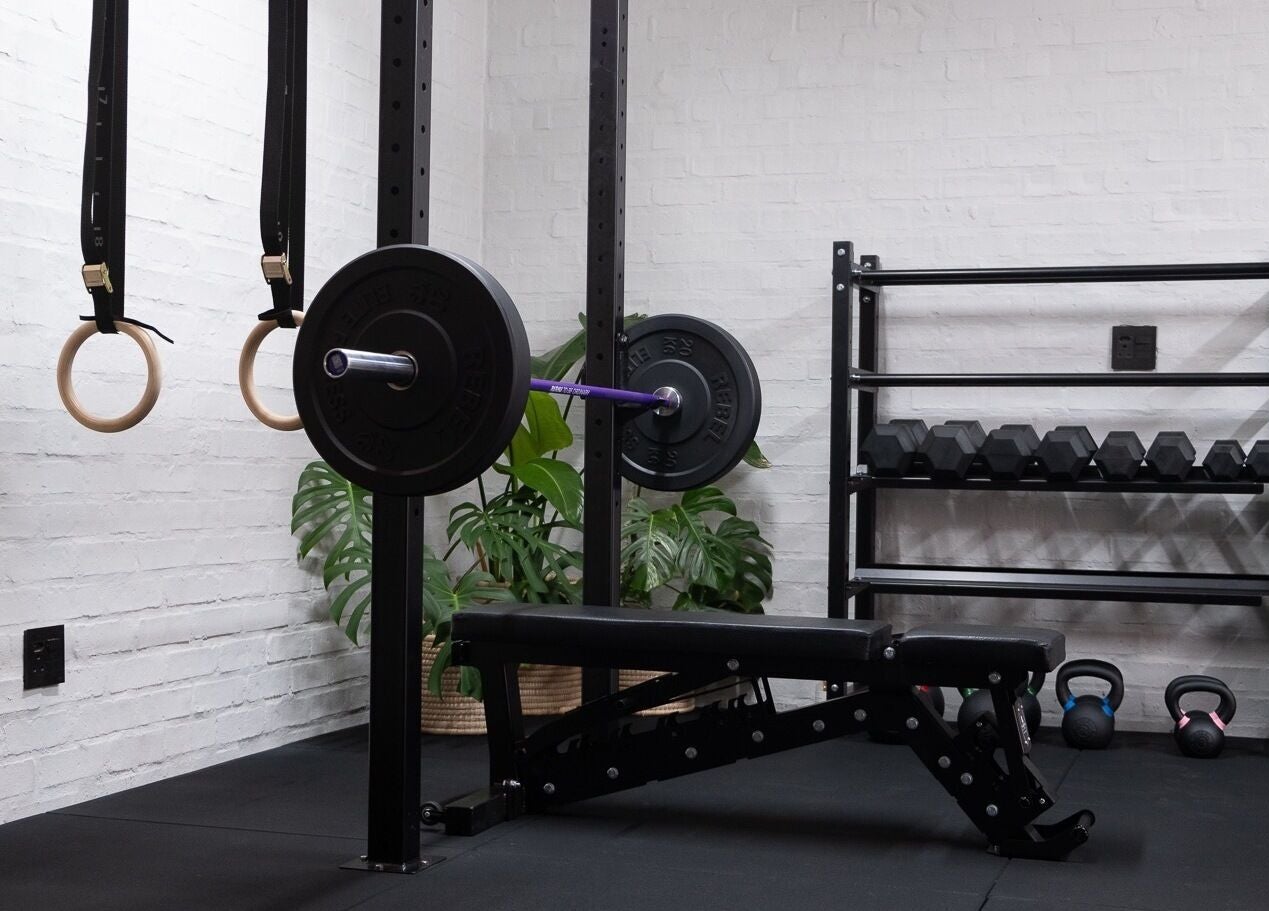 Modern gym setup at Seal Hybrid Performance, Cape Saint Francis, Eastern Cape, ZA, featuring weights and gym rings.