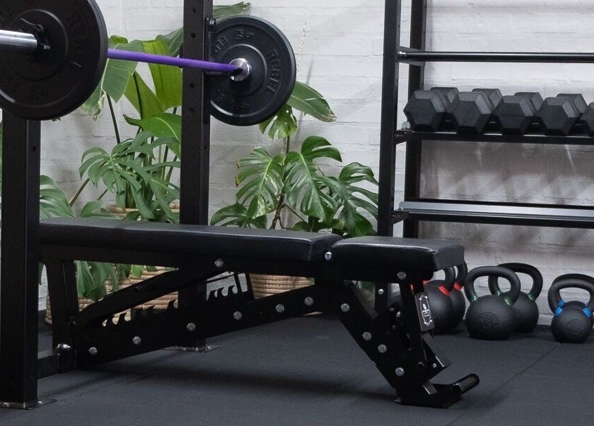 Gym setup at Seal Hybrid Performance, Cape Saint Francis, Eastern Cape, ZA showcasing weights and bench.