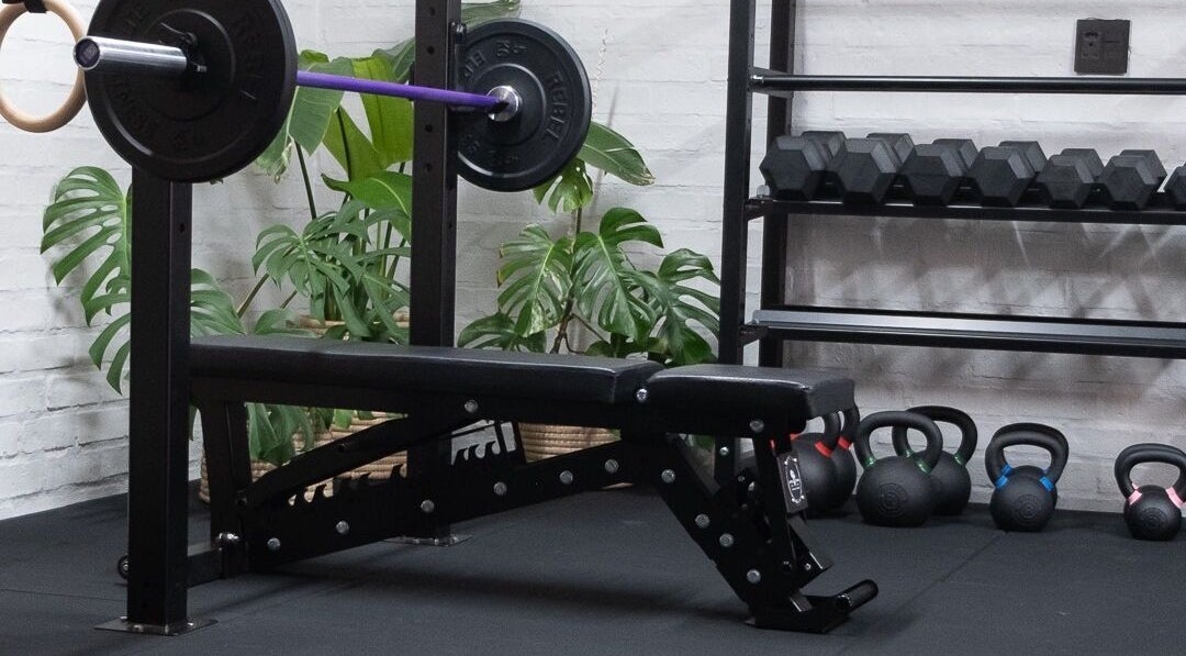 Gym setup at Seal Hybrid Performance, Cape Saint Francis, Eastern Cape, ZA showcasing weights and bench.