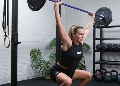 Woman weightlifting at Seal Hybrid Performance, Cape Saint Francis, Eastern Cape, ZA in modern gym setting.