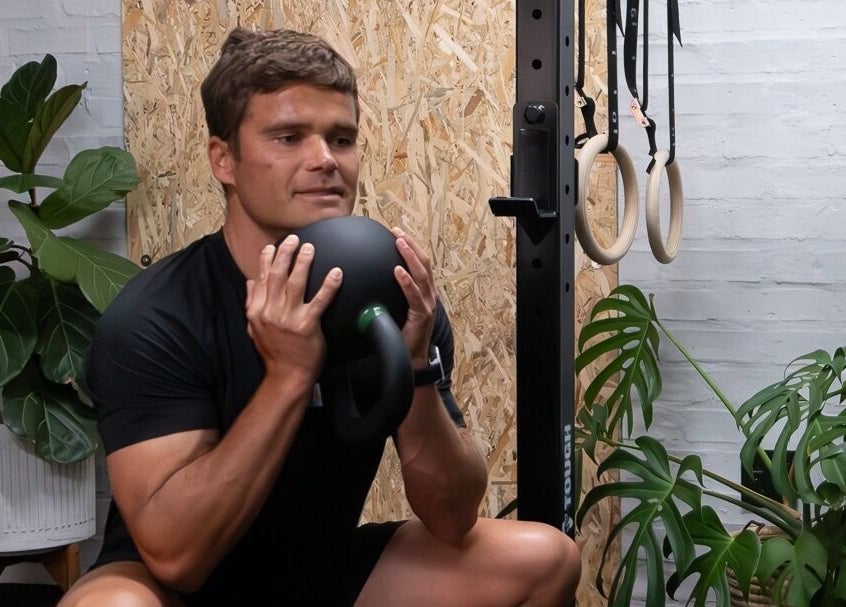 Man exercising with kettlebell at Seal Hybrid Performance, Cape Saint Francis, Eastern Cape, ZA.