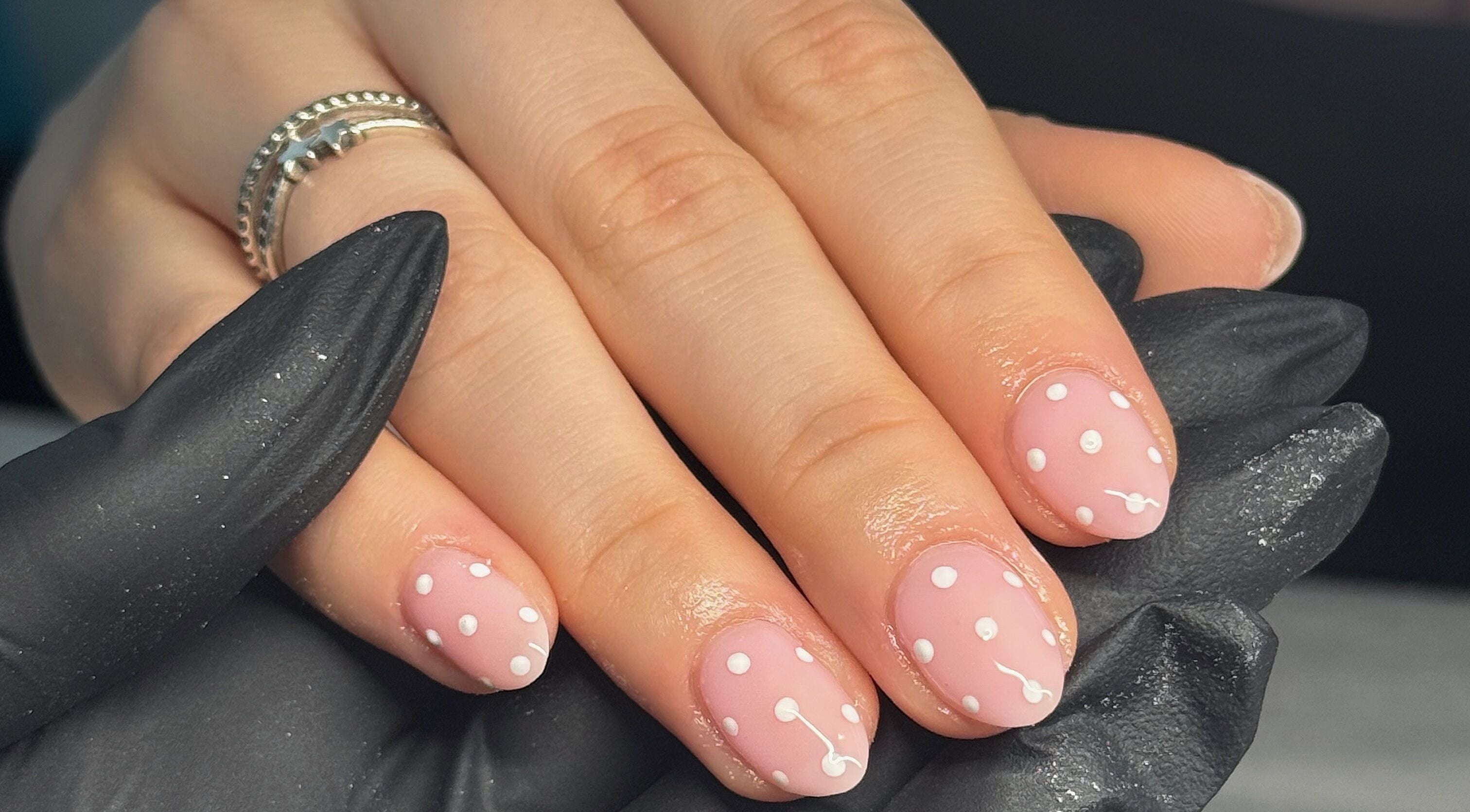 Elegant polka dot nail art at Touch Of Beauty, Blyth, England, GB, showcasing stylish pink and white design.