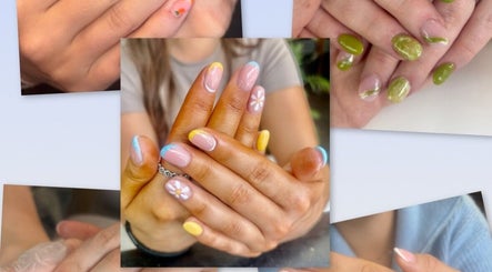Colorful nail art with floral designs at Beauty Bound by Alex, Flint, Wales, GB. Bright and vibrant manicure display.