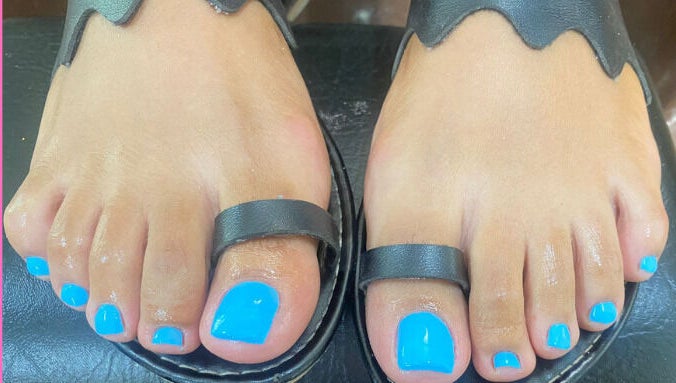 Bright blue pedicure at Pure Bliss Spa, Roseau, Saint George Parish, DM, showcasing perfect nail art.
