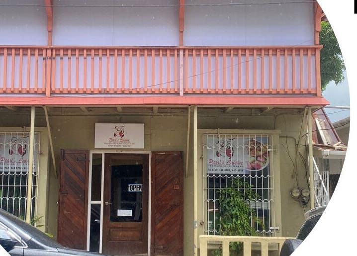 Front view of Pure Bliss Spa with charming architecture in Roseau, Saint George Parish, DM.