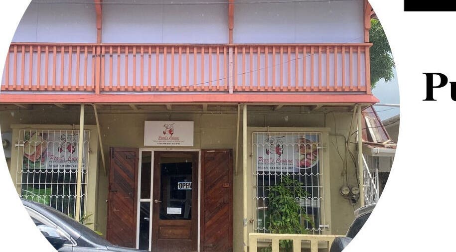 Front view of Pure Bliss Spa with charming architecture in Roseau, Saint George Parish, DM.