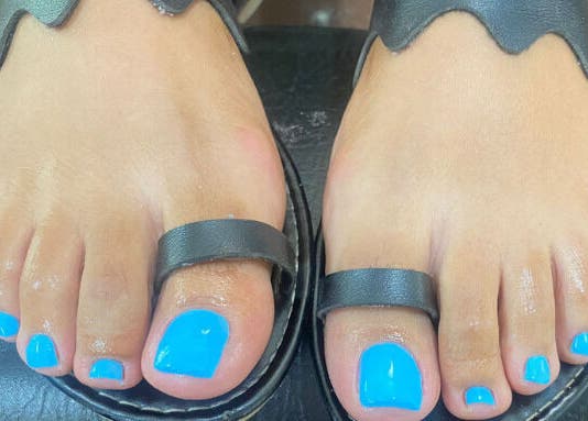 Bright blue pedicure at Pure Bliss Spa, Roseau, Saint George Parish, DM. Perfectly polished toenails.