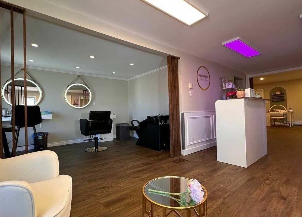 Inside Peony Bliss Beauty Bar, Dieppe, NB, elegant salon with modern decor and cozy seating atmosphere.