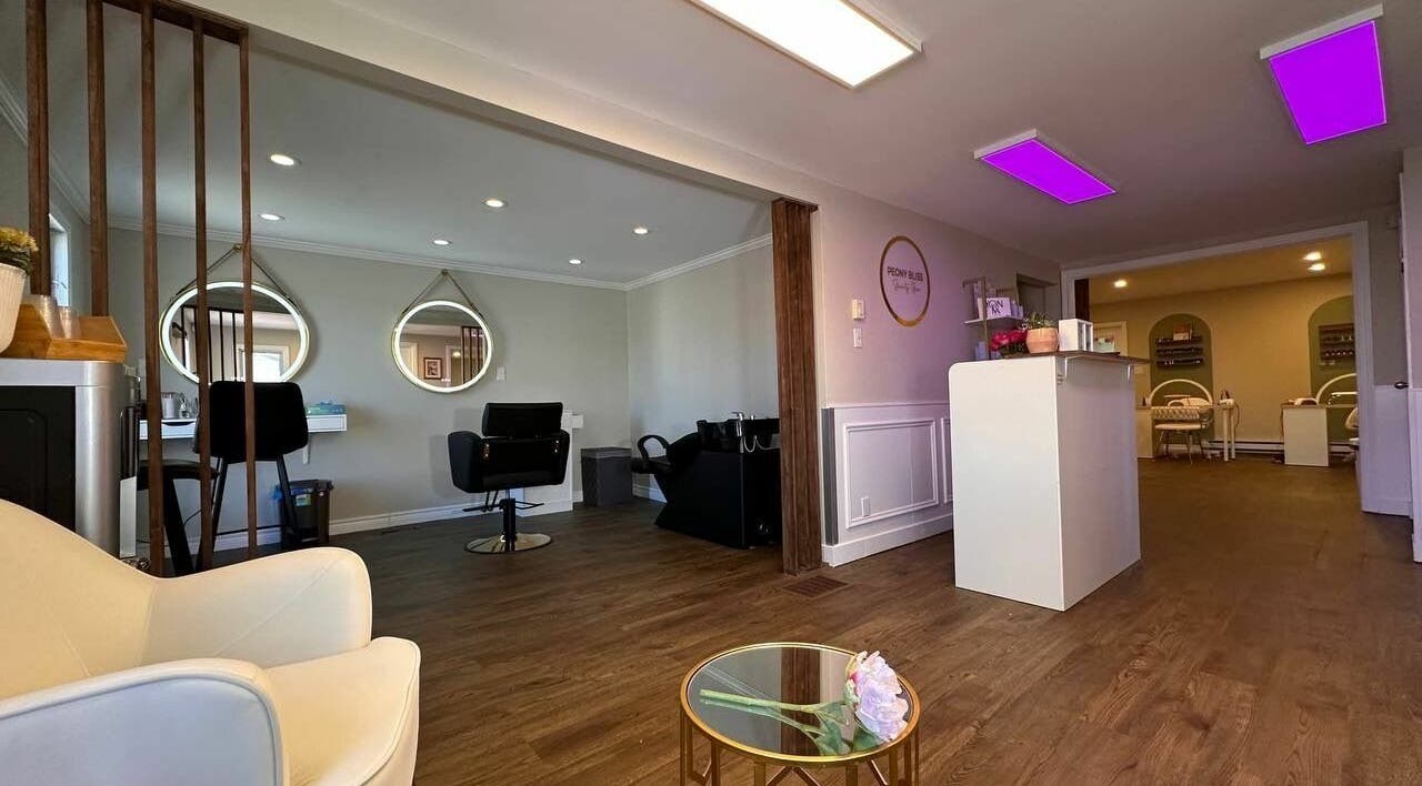 Inside Peony Bliss Beauty Bar, Dieppe, NB, elegant salon with modern decor and cozy seating atmosphere.
