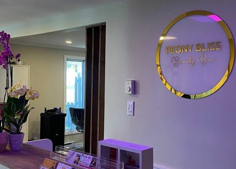 Reception of Peony Bliss Beauty Bar in Dieppe, New Brunswick, CA adorned with orchids.