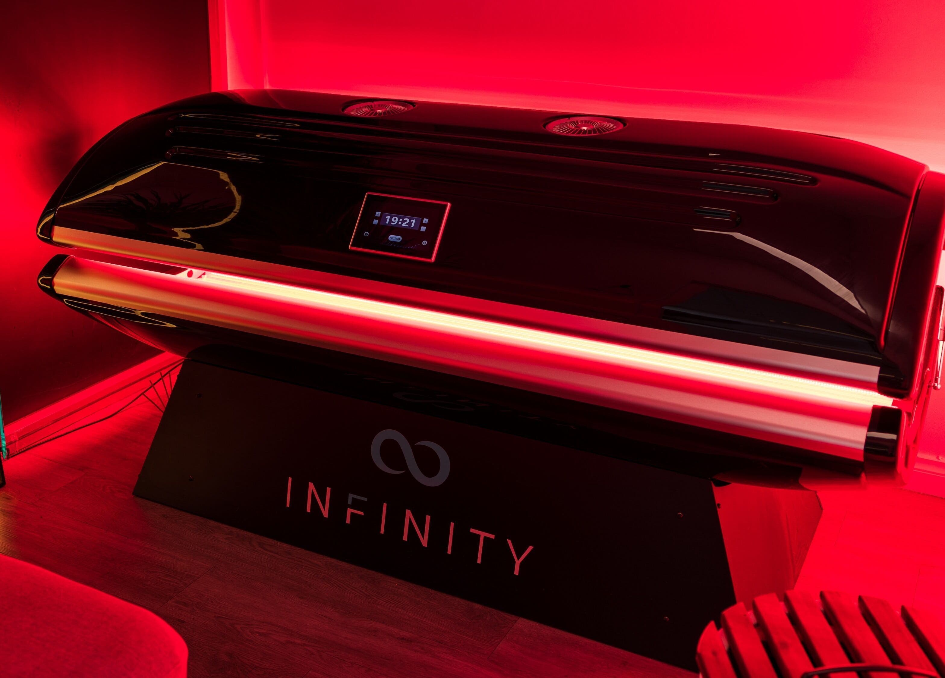 Modern tanning booth at Breathe WRL, Glenelg East, South Australia, AU with ambient red lighting.