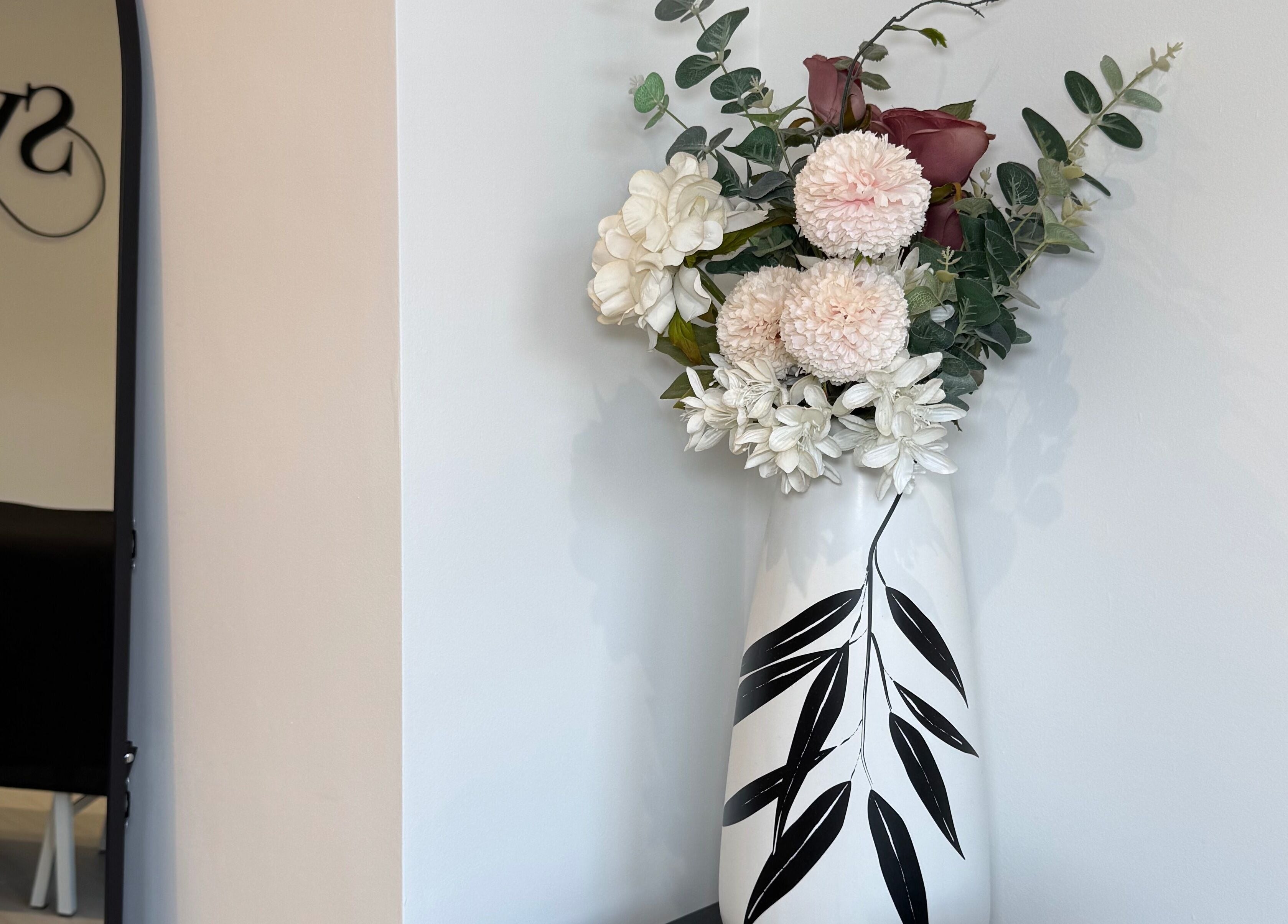 Elegant floral arrangement in vase at SW Aesthetics, Kent, England, GB, enhancing serene ambiance.