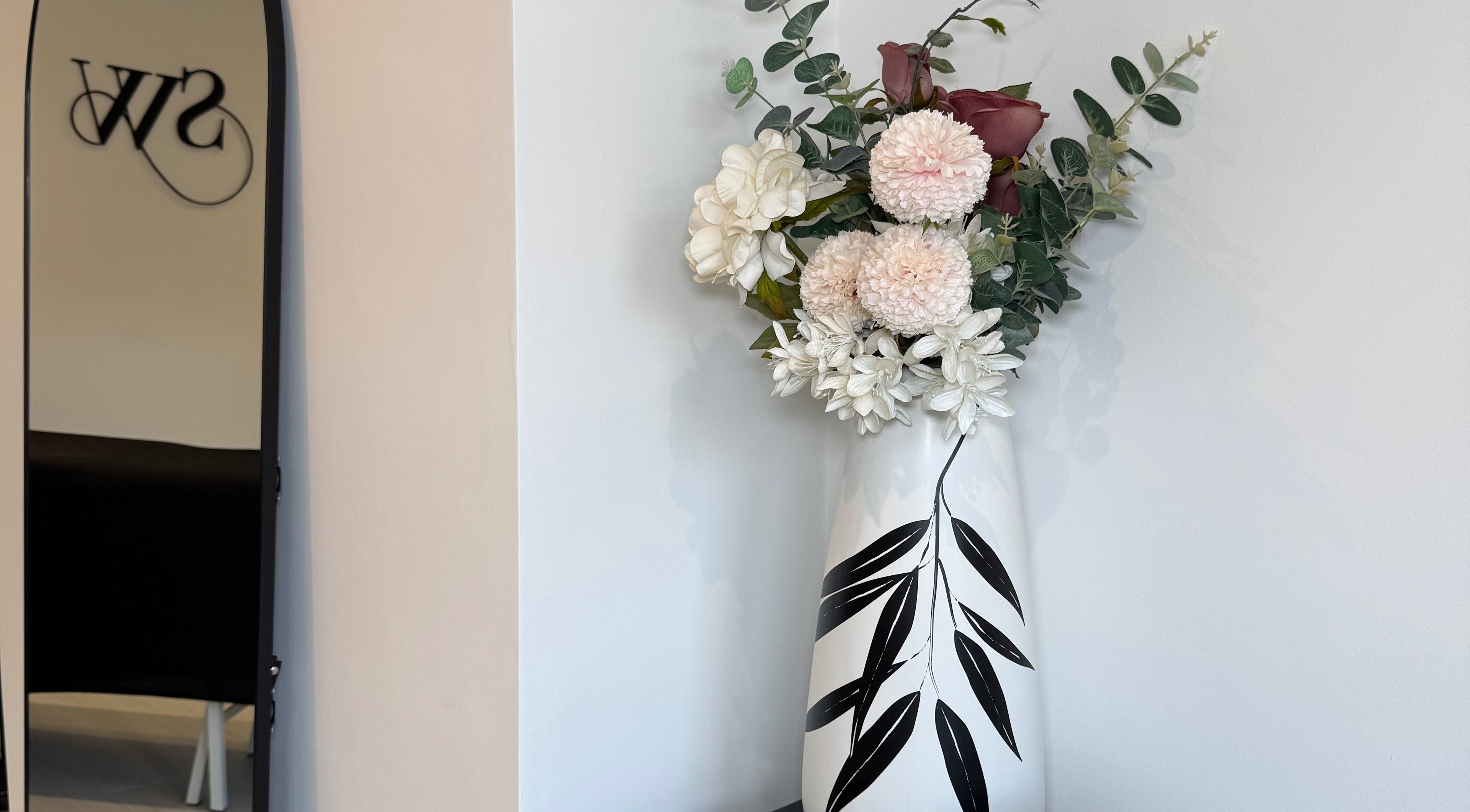 Elegant floral arrangement in vase at SW Aesthetics, Kent, England, GB, enhancing serene ambiance.