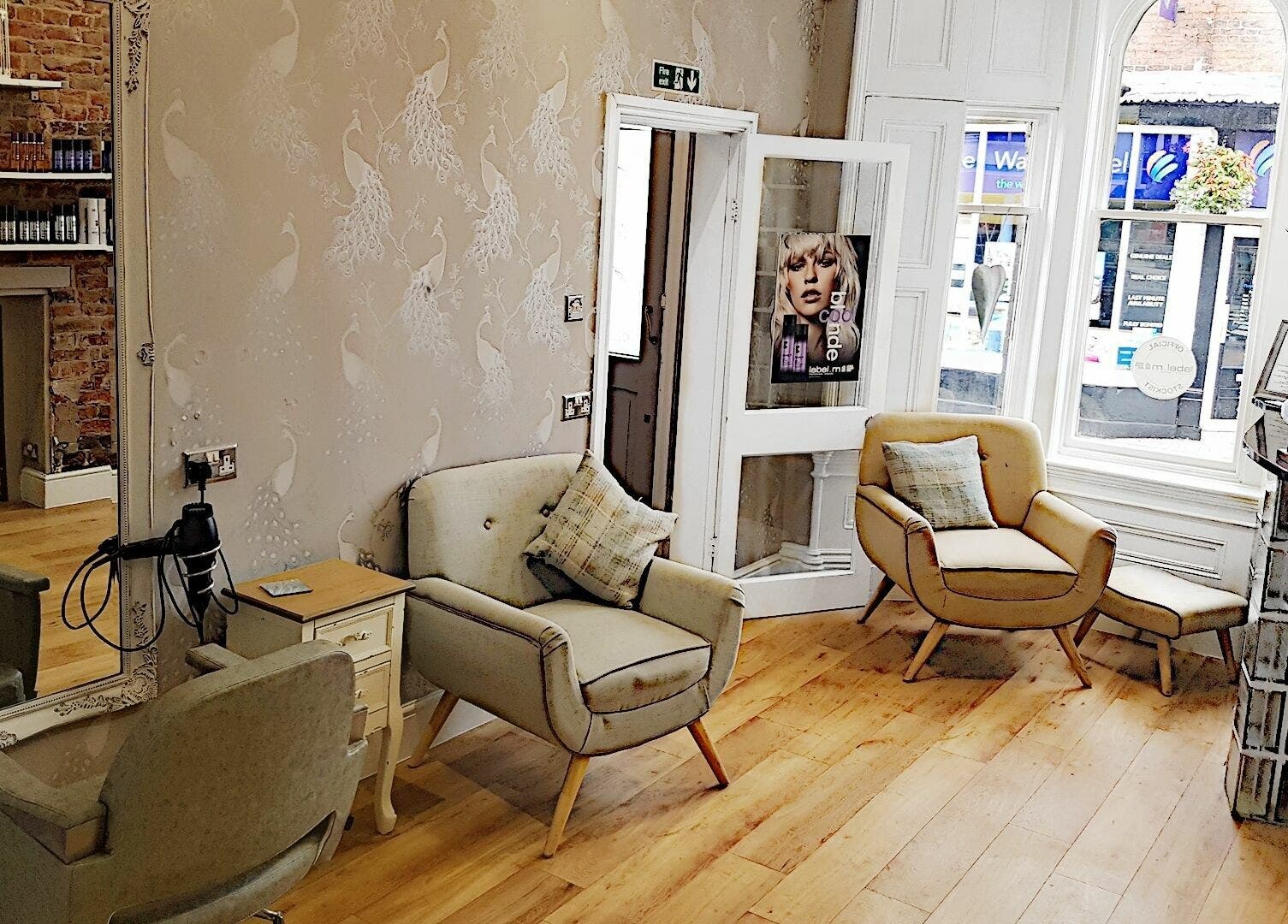 Elegant salon interior at Halo, Congleton, England, GB featuring stylish chairs and wooden flooring.