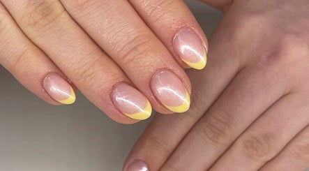 Close-up of elegant yellow-tipped nails at Beauty Fox, Glasgow, Scotland, GB.