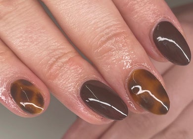 Brown nail art at Beauty Fox, Glasgow, Scotland, GB showcasing glossy tiger-eye designs.